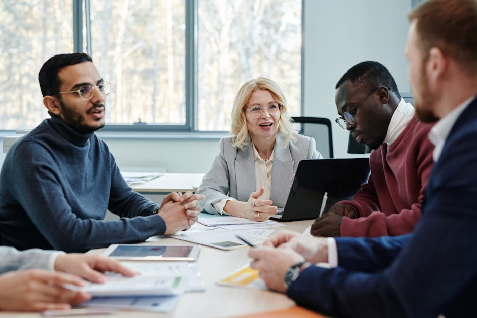 Group of professionals in a meeting discussing teamwork in an office